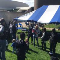 GVSU volleyball alumni, friends, and family outside at a tailgate